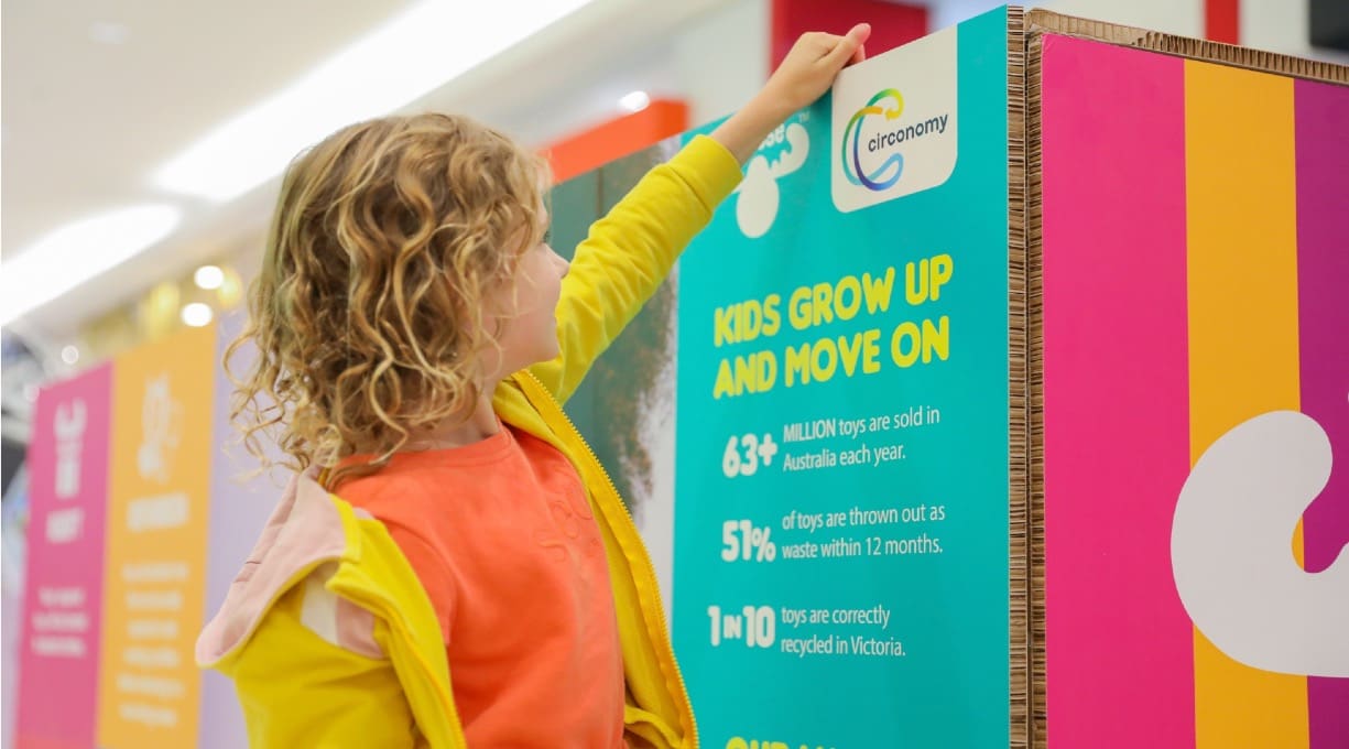 Girl putting toy in a bin