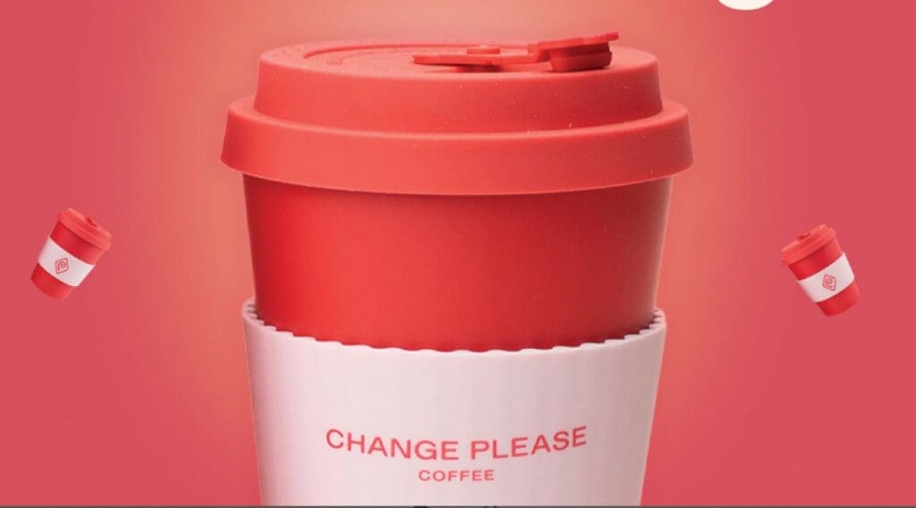 close up image of a reusable coffee cup made by Ecoffee Cup and featuring Change Please branding