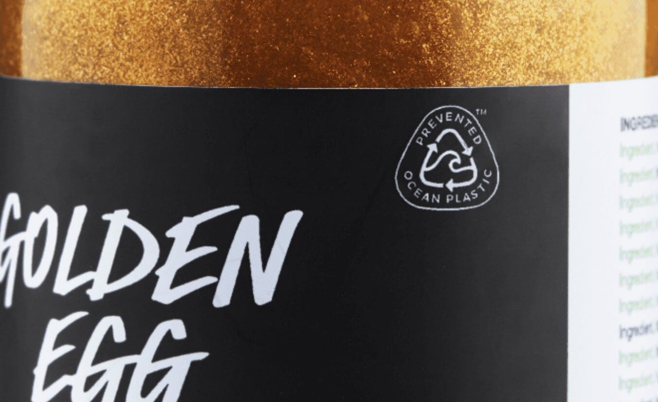 Close up on Lush bottled product and label with focus on Prevented Ocean Plastic symbol.