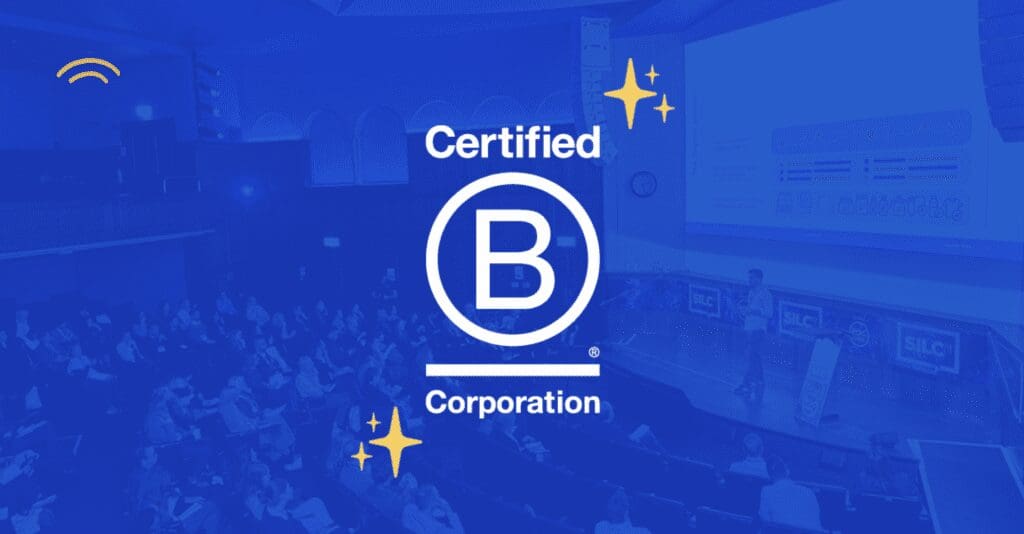 Dayrize logo and B Corp announcement overlayed on image of Dayrize speaking at SiLC 2023