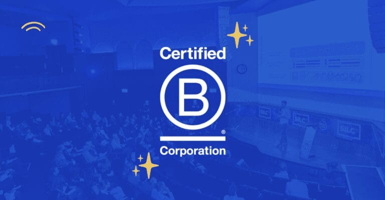 Dayrize logo and B Corp announcement overlayed on image of Dayrize speaking at SiLC 2023