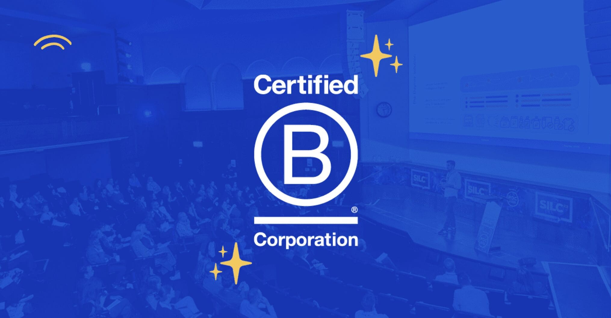Dayrize logo and B Corp announcement overlayed on image of Dayrize speaking at SiLC 2023
