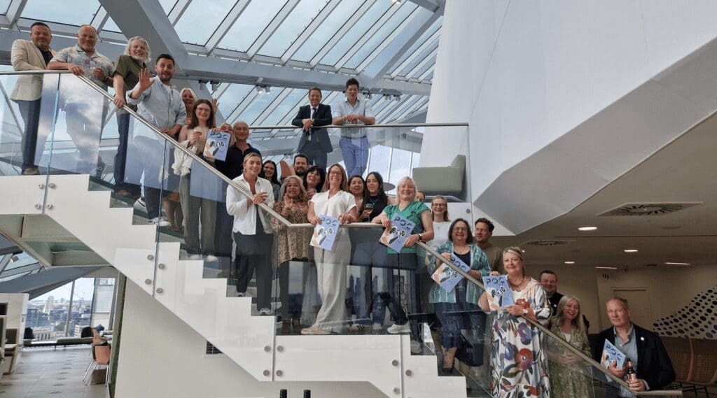 Products of Change members line up on the stairs at the Informa offices in London