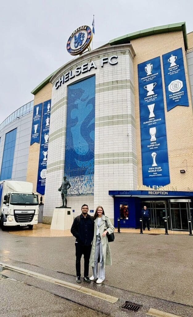 Chelsea FC stadium Stamford Bridge with two people from Fabacus standing in front.