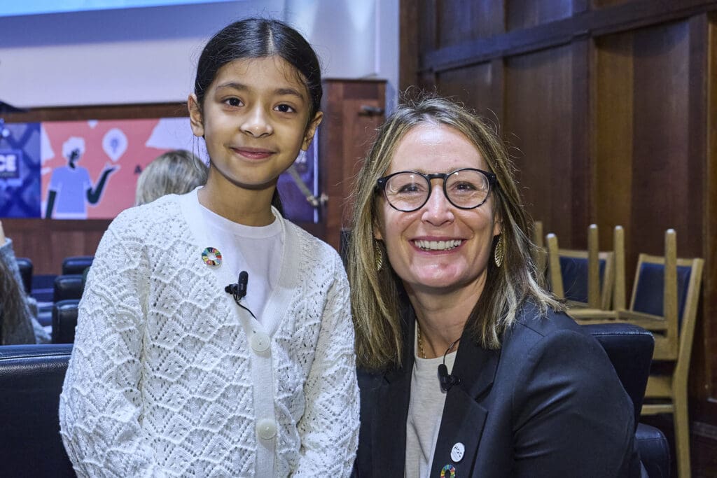 Moksha Roy and Helena Mansell-Stopher smile at the camera.