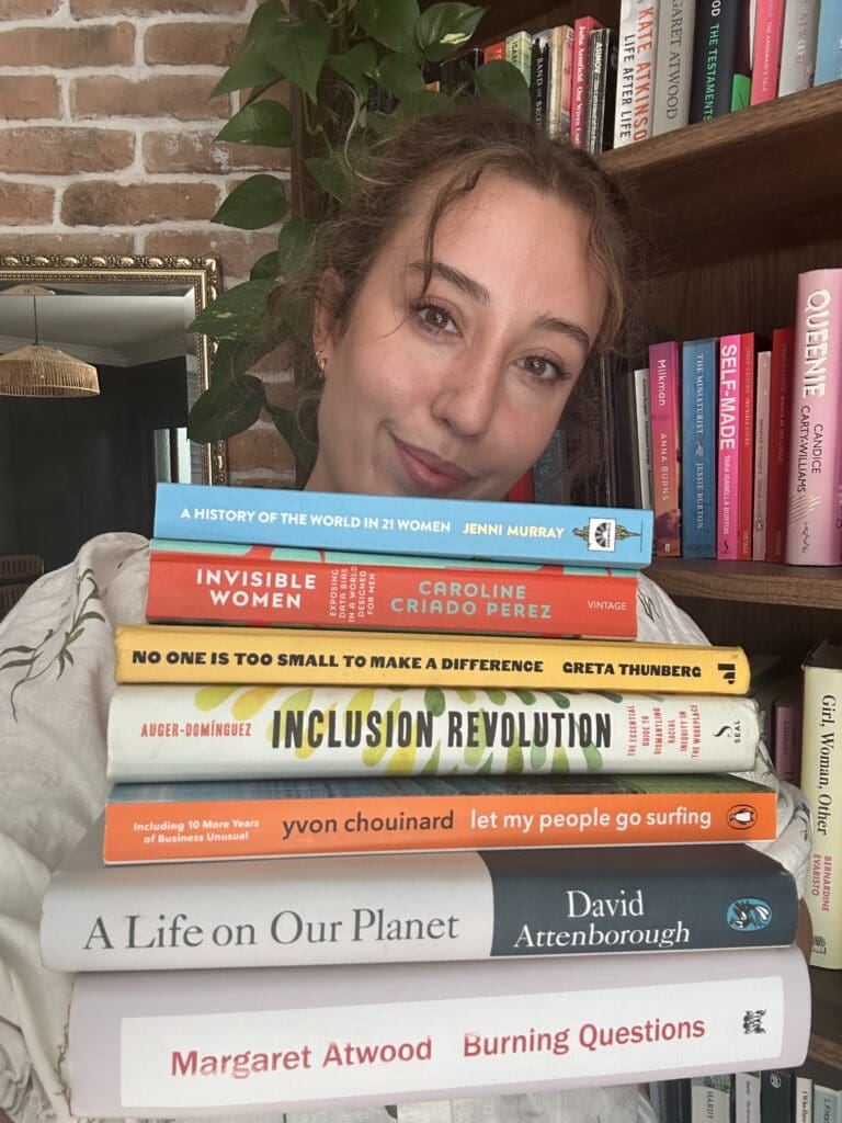 Kathryn holding a stack of books