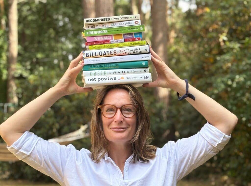 Helena with a stack of books on her head.