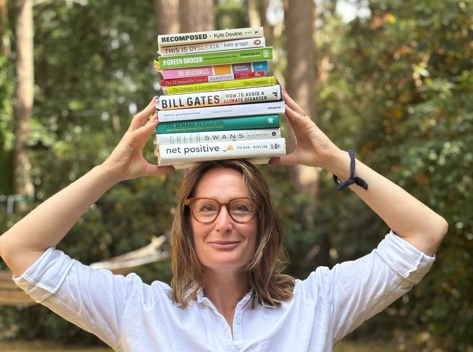 Helena with a stack of books on her head.